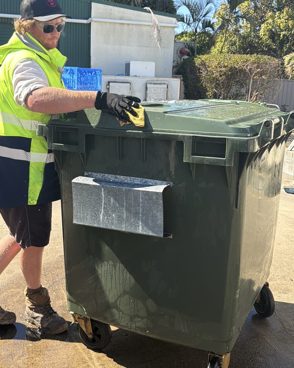 Wiping down a clean 1100L commercial bin